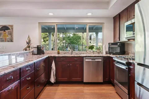 a bathroom with a granite countertop sink and mirror
