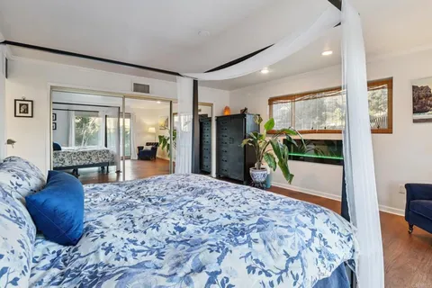 a bathroom with a granite countertop sink a mirror and shower