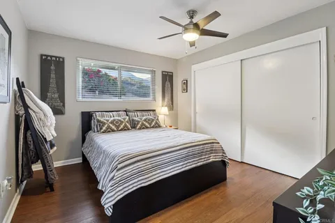 a bathroom with a toilet a sink a mirror and a window