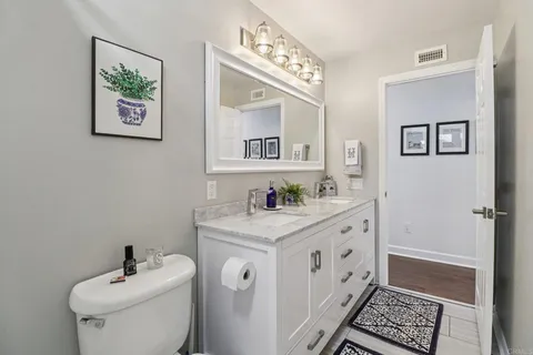a bathroom with a toilet a sink and a mirror