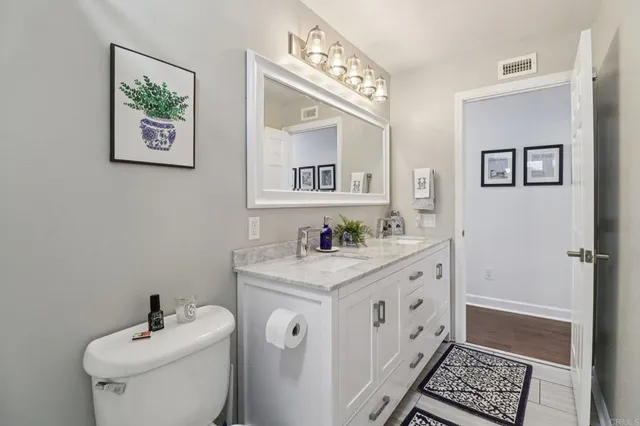 a bathroom with a toilet a sink and a mirror