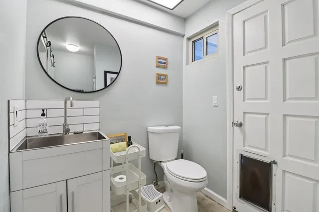 a view of a house with backyard sitting area and garden