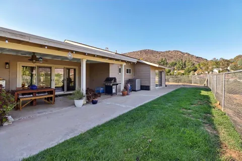 an aerial view of a house with a mountain