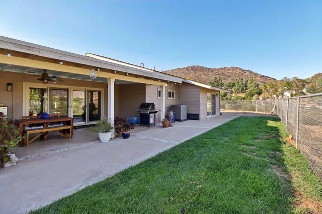 an aerial view of a house with a mountain