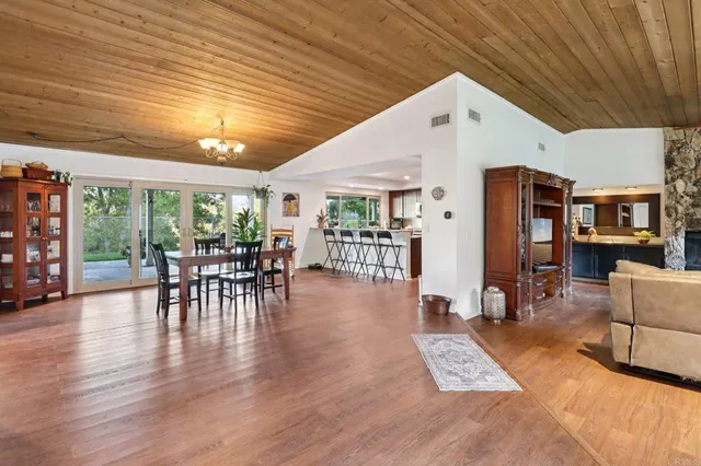 a living room with furniture a rug potted plant and a large window