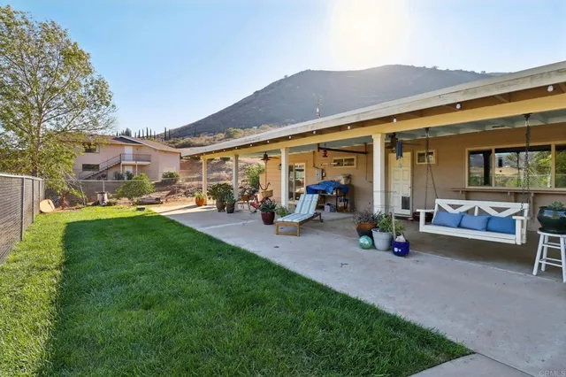 an aerial view of a house with a yard and large trees