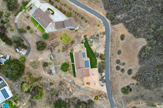 a view of a house with a yard and sitting area