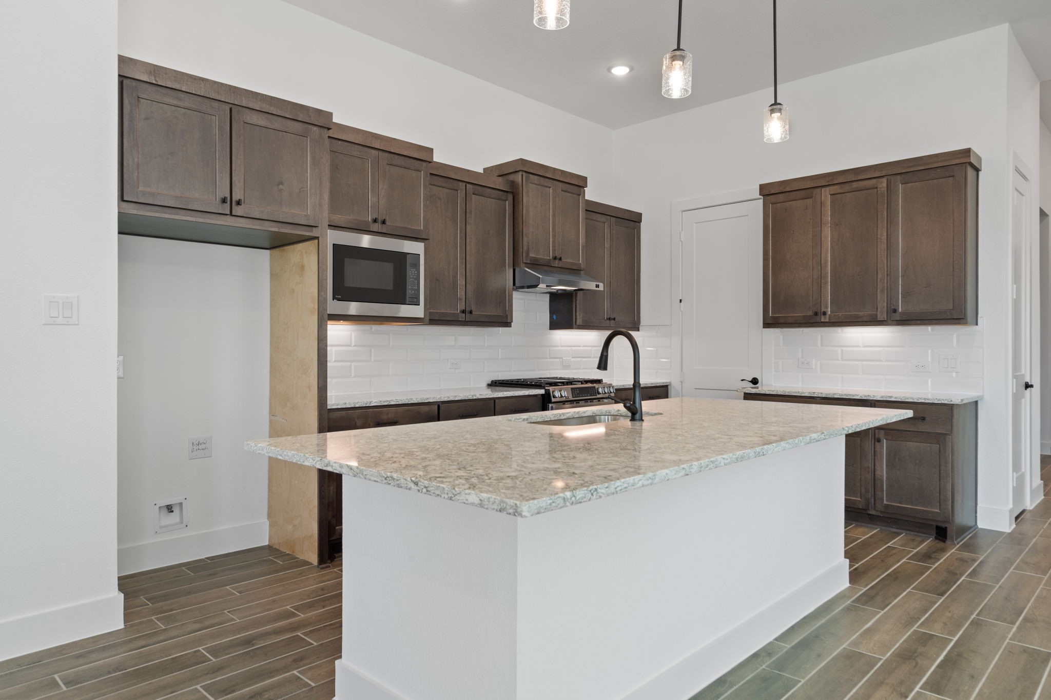 12002 Rice View Drive Mont Belvieu, TX 77523 - Photo 12 of 50 a kitchen with stainless steel appliances granite countertop a sink a microwave counter space and cabinets