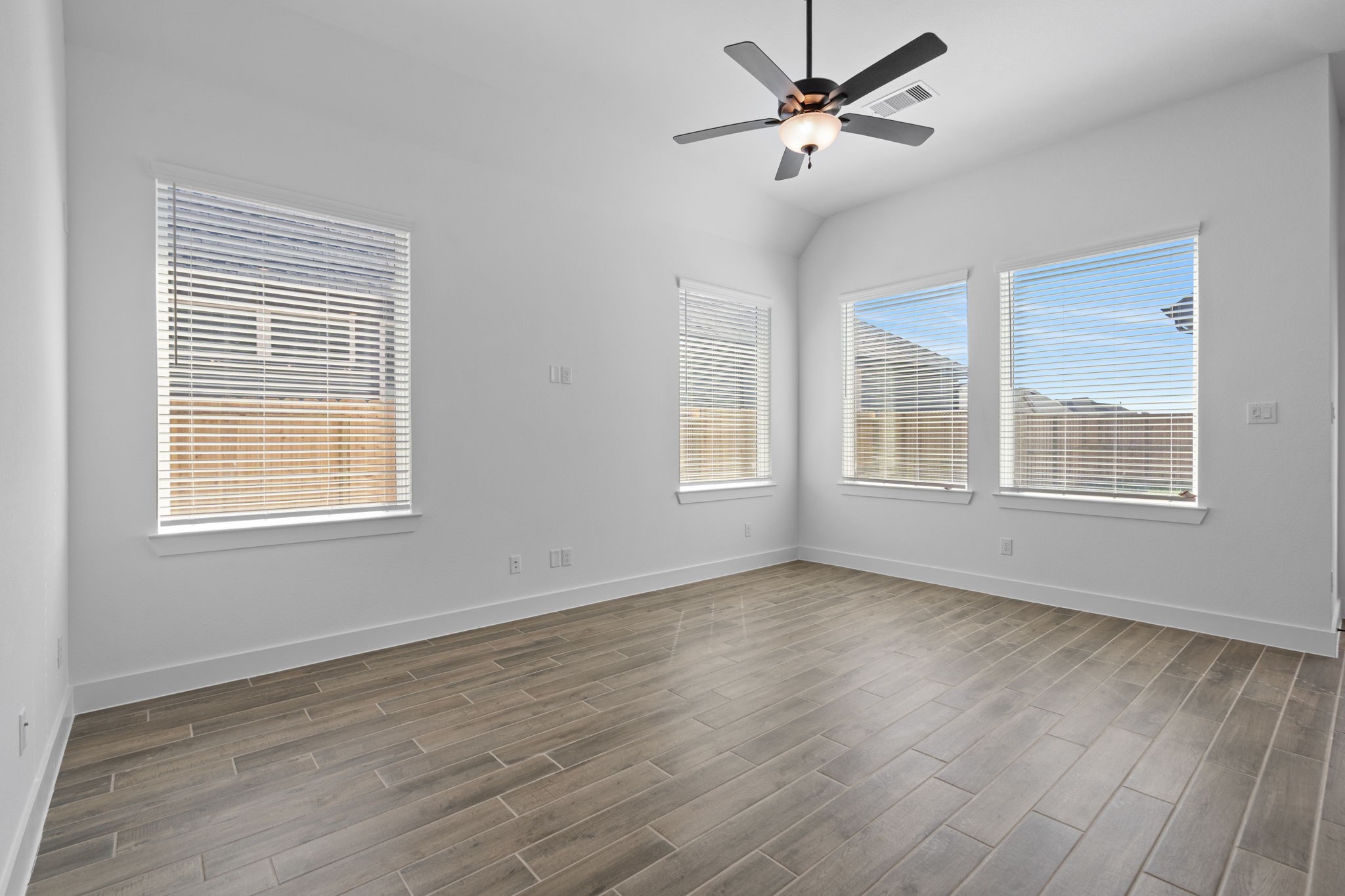 12002 Rice View Drive Mont Belvieu, TX 77523 - Photo 17 of 50 a view of an empty room with a window and wooden floor