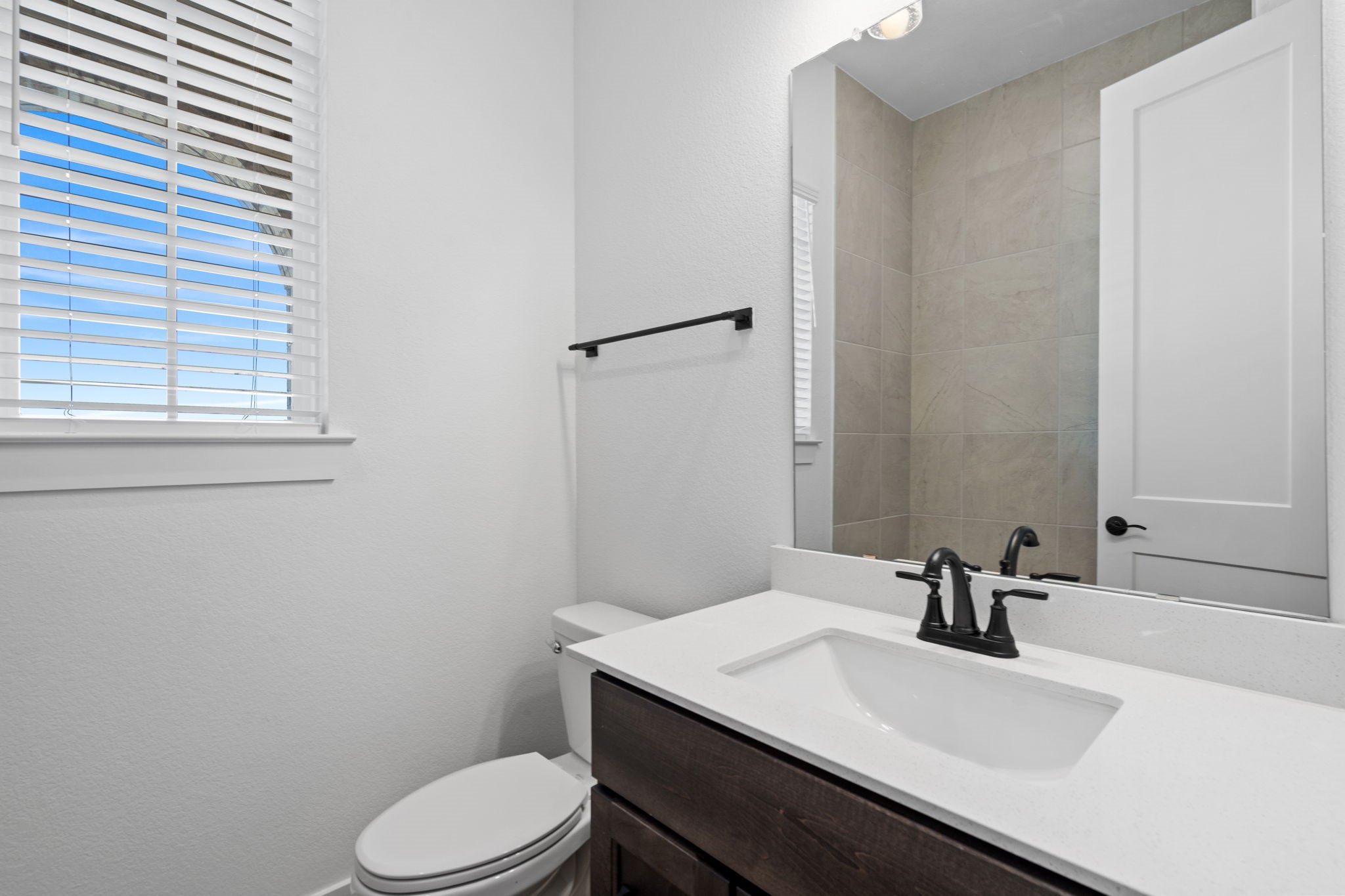 12002 Rice View Drive Mont Belvieu, TX 77523 - Photo 21 of 50 a bathroom with a sink a toilet a mirror and shower