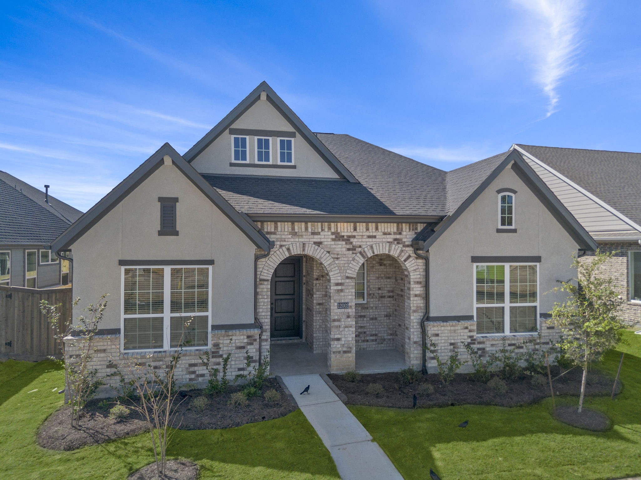 12002 Rice View Drive Mont Belvieu, TX 77523 - Photo 4 of 50 a front view of a house with a yard and outdoor seating
