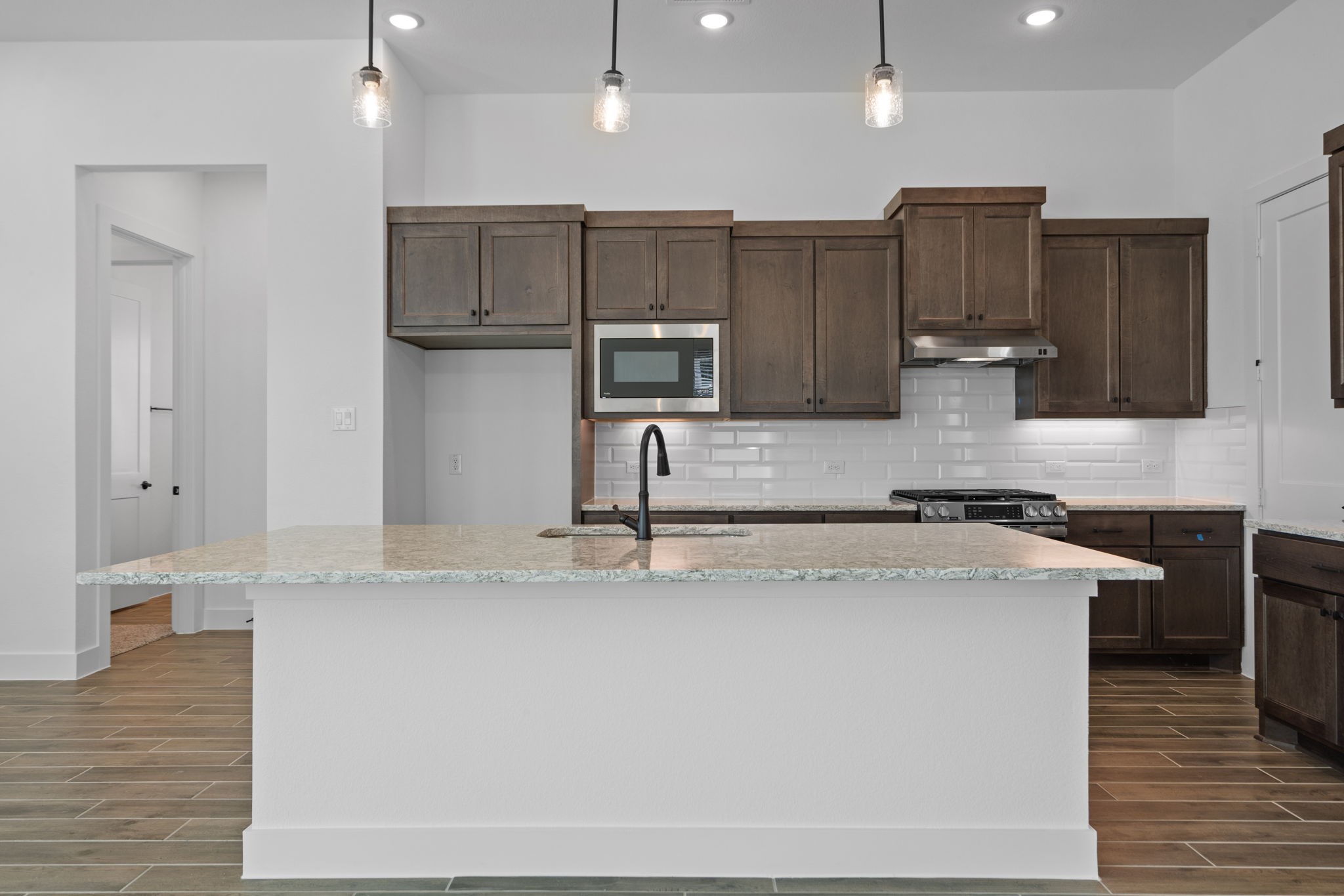 12002 Rice View Drive Mont Belvieu, TX 77523 - Photo 9 of 50 a kitchen with stainless steel appliances granite countertop a sink a stove and a refrigerator