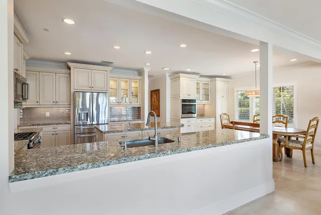 a living room with furniture and large windows