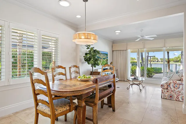 a view of a dining room and livingroom with furniture wooden floor a chandelier