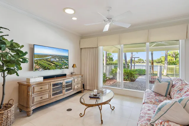 a view of a dining room and livingroom with furniture wooden floor a chandelier