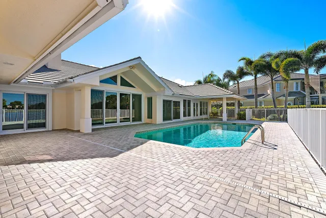 a kitchen with stainless steel appliances wooden floor and a refrigerator