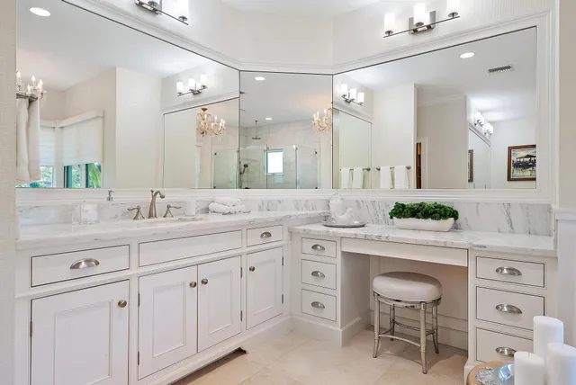 a bathroom with a granite countertop sink a toilet and shower