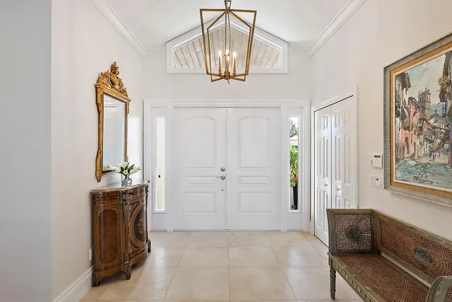 a living room with furniture a fireplace and a large window