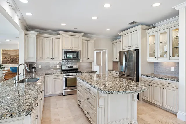 a kitchen with a large window and dining table