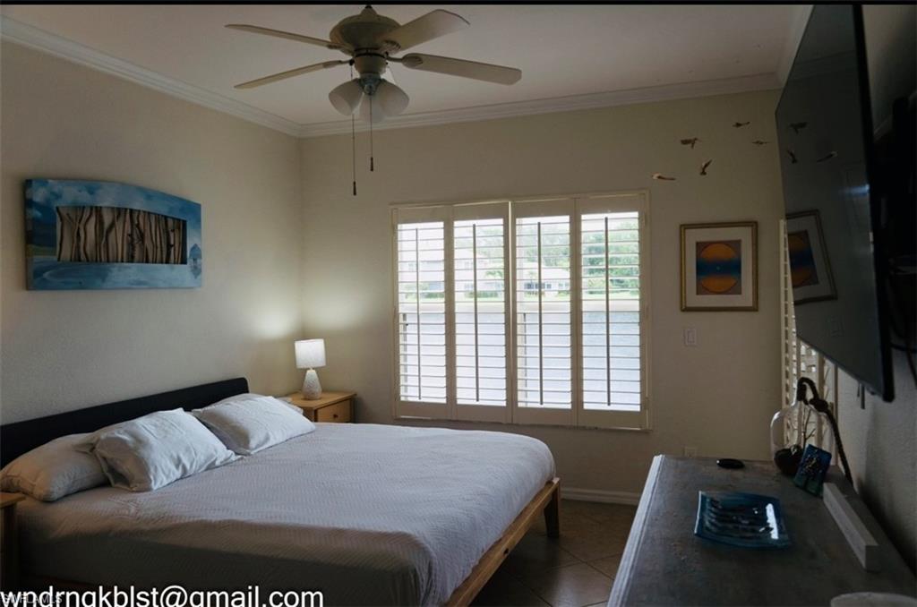 298 Emerald Bay Circle, Unit K6 Naples, FL 34110 - Photo 6 of 9 a bedroom with a bed and a window