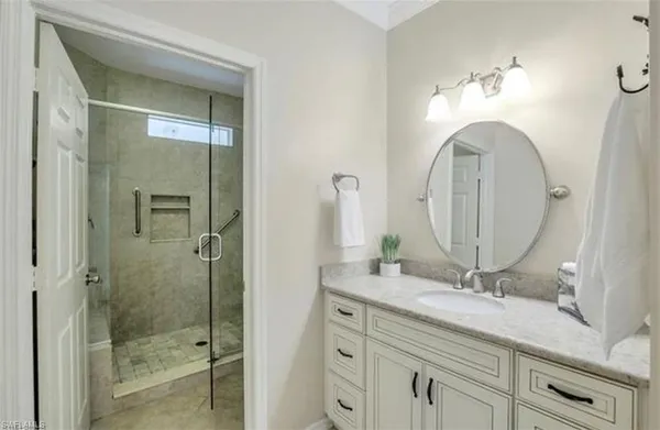 a bathroom with a double vanity sink and a mirror