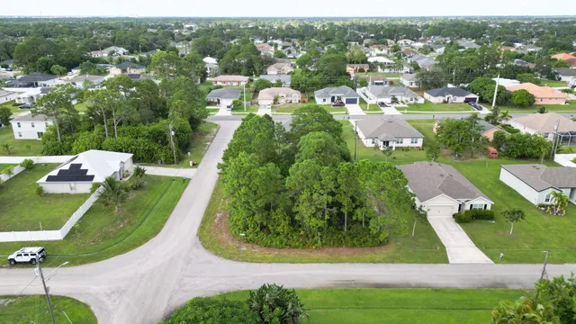 an aerial view of a house with a garden and lake view
