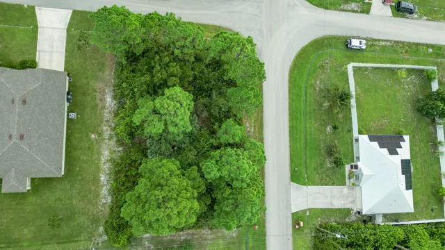an aerial view of a house with garden space and street view