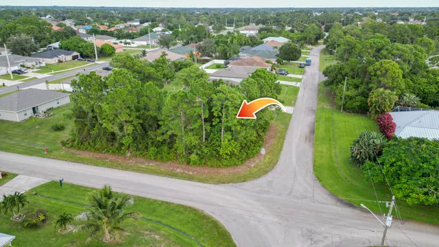 an aerial view of residential houses with outdoor space and street view