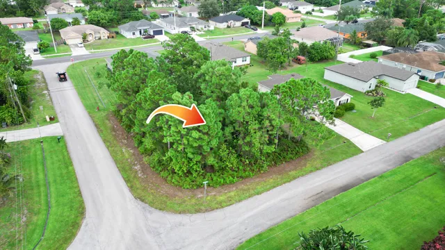 an aerial view of residential houses with outdoor space and street view