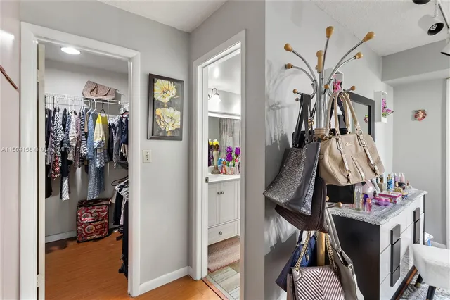 a view of walk in closet with clothes and shoes