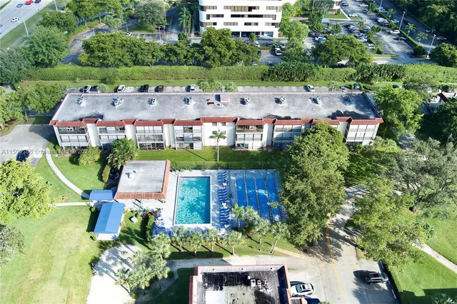 an aerial view of a house with a yard basket ball court and outdoor seating
