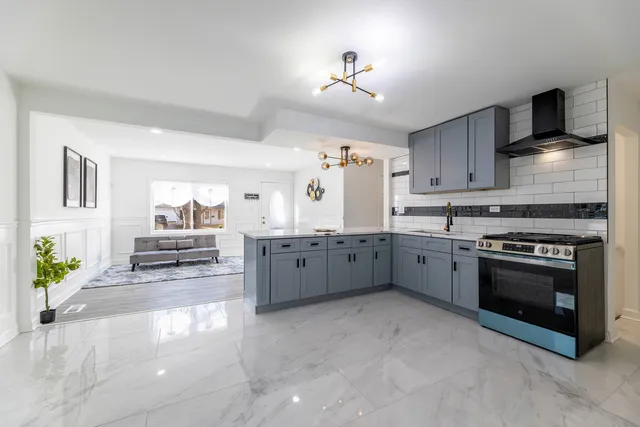 a kitchen with stainless steel appliances a stove a sink and a refrigerator