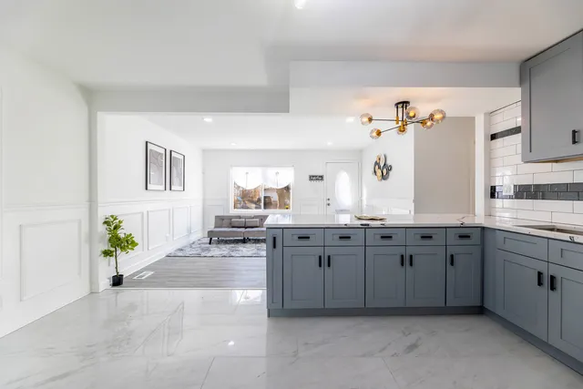 a spacious bathroom with a granite countertop sink a mirror and a vanity
