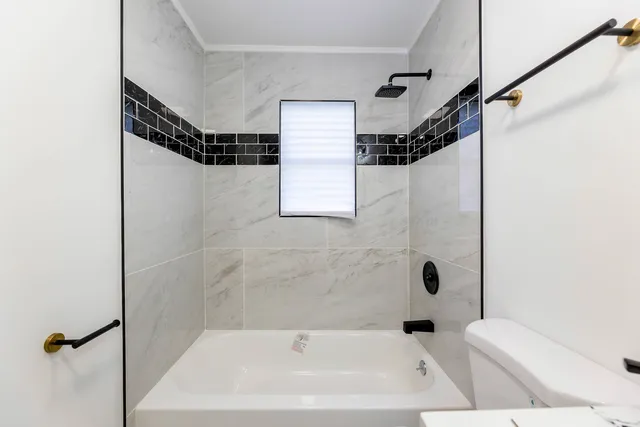 a bathroom with a bathtub and shower