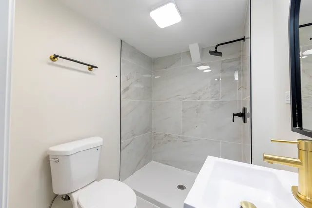 a bathroom with a toilet and a shower