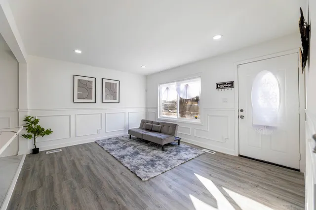 a living room with furniture and a potted plant