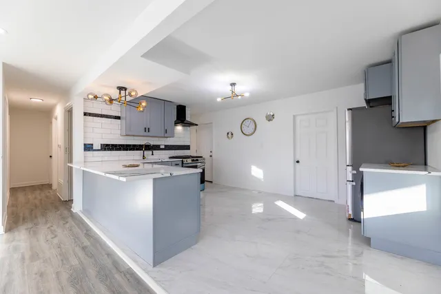 a kitchen with a sink and a stove top oven