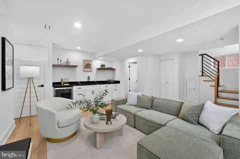 a living room with furniture a potted plant and a fireplace
