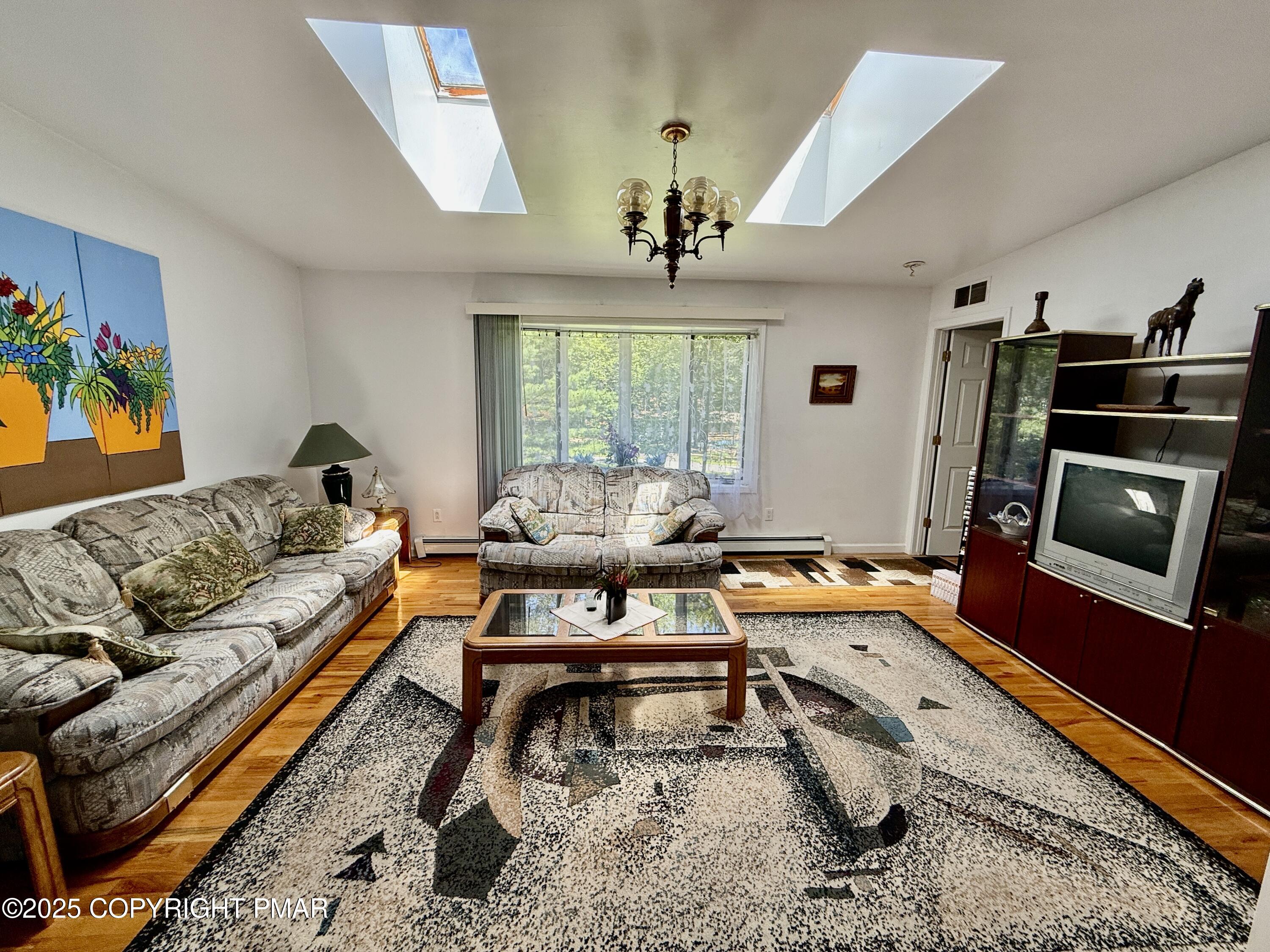 3224 Lakeview Drive Henryville, PA 18332 - Photo 14 of 48 a living room with furniture flat screen tv and a fireplace