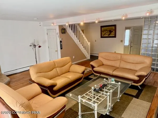 a living room with furniture and a flat screen tv