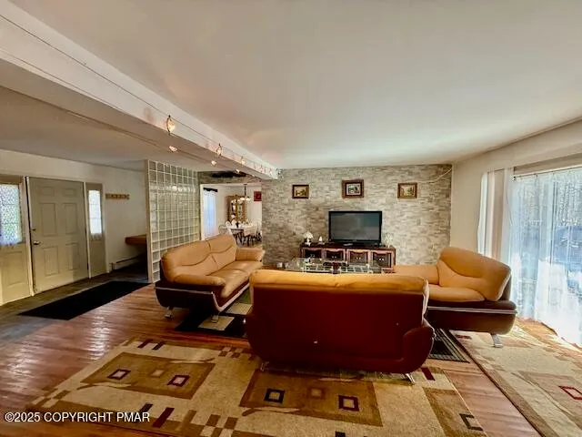 a living room with furniture and a wooden floor