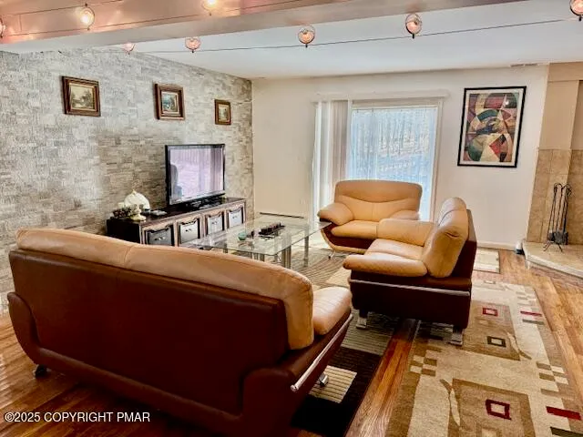 a living room with furniture and a flat screen tv