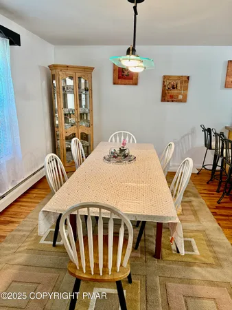 a view of a dining room with furniture and a kitchen