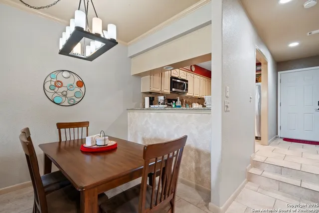 a view of a dining room with furniture and a chandelier