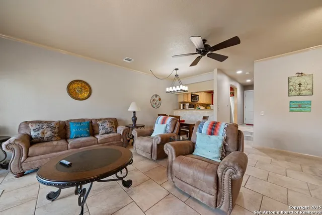 a living room with furniture and kitchen view