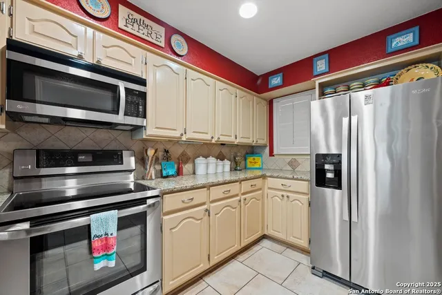 a kitchen with stainless steel appliances and cabinets