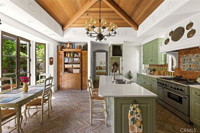 a view of a dining room with furniture wooden floor and chandelier