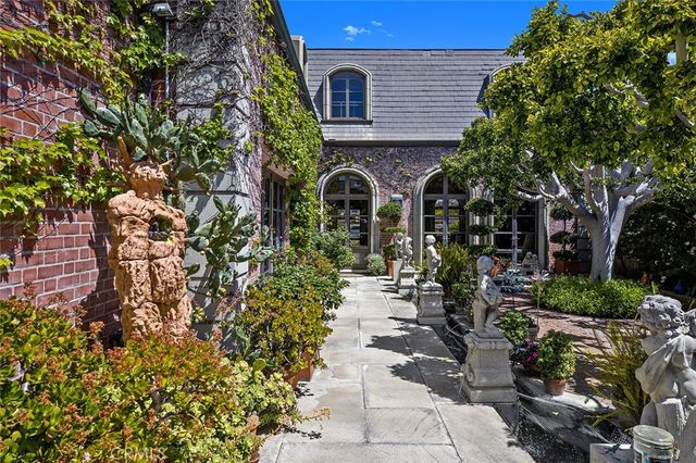 a view of a house with a flower garden