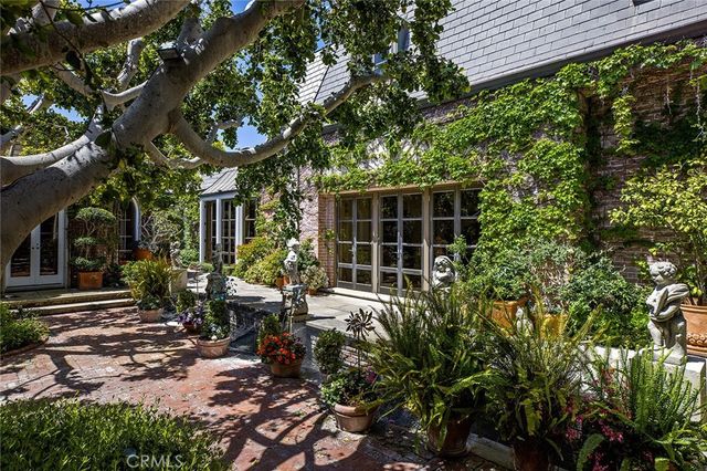 a view of a house with sitting area and garden