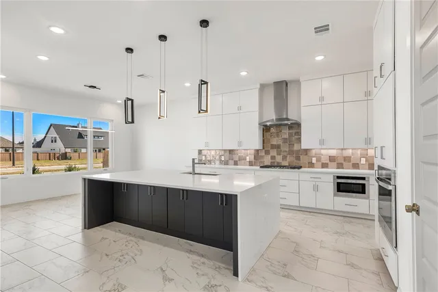 a kitchen with stainless steel appliances granite countertop a sink and cabinets